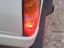 Driver side. When the tail light is lit, no bleed through into reverse reflector