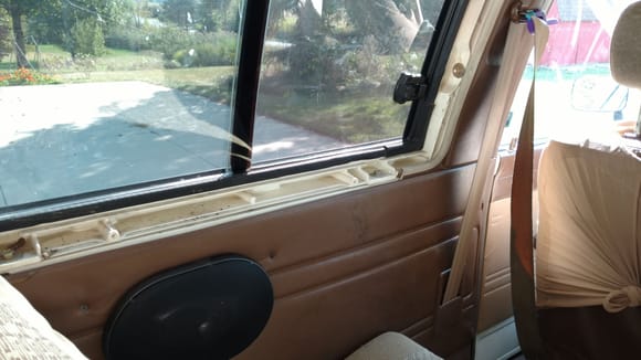 The trim runs under the sliding window and covers the bolts holding on the cap.