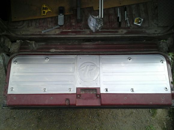 2 peice, well technically 3 peice tailgate panel. Trying to make shipping easier, the two halves overlap with a stepjoint, then there will be a center cover that bolts tne two halves together.