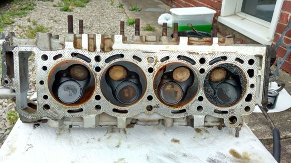 All combustion chambers look bad with crispy burnt valves, but #4 was by far the worst. Is that damage all from detonation? There was nothing in there there that would cut into metal like that.