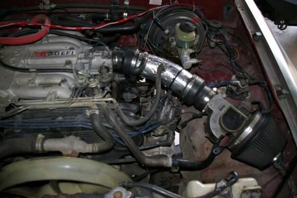 Cold air intake mod, using 3" electrical conduit sweep.  Wrapped with reflective tape afterwards.
