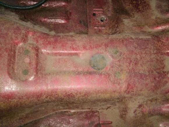 Here you have a good view of the console places to drill through, in the upper section is the "flat" for a conversion from bench to bucket seats..

This is a 1994 model year, yours maybe different  but similar they used the same style (one stamping with holes drilled and blind nuts added depending on build spec)