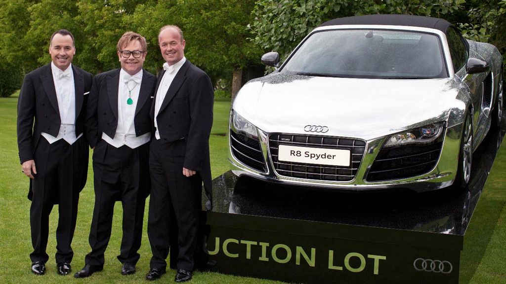 Elton John with friends and the chrome Audi R8 Spyder