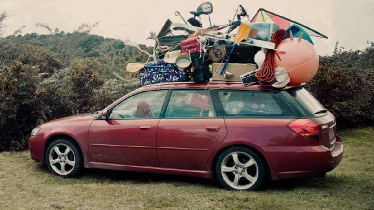 Overloaded Subaru Legacy with stuff on roof