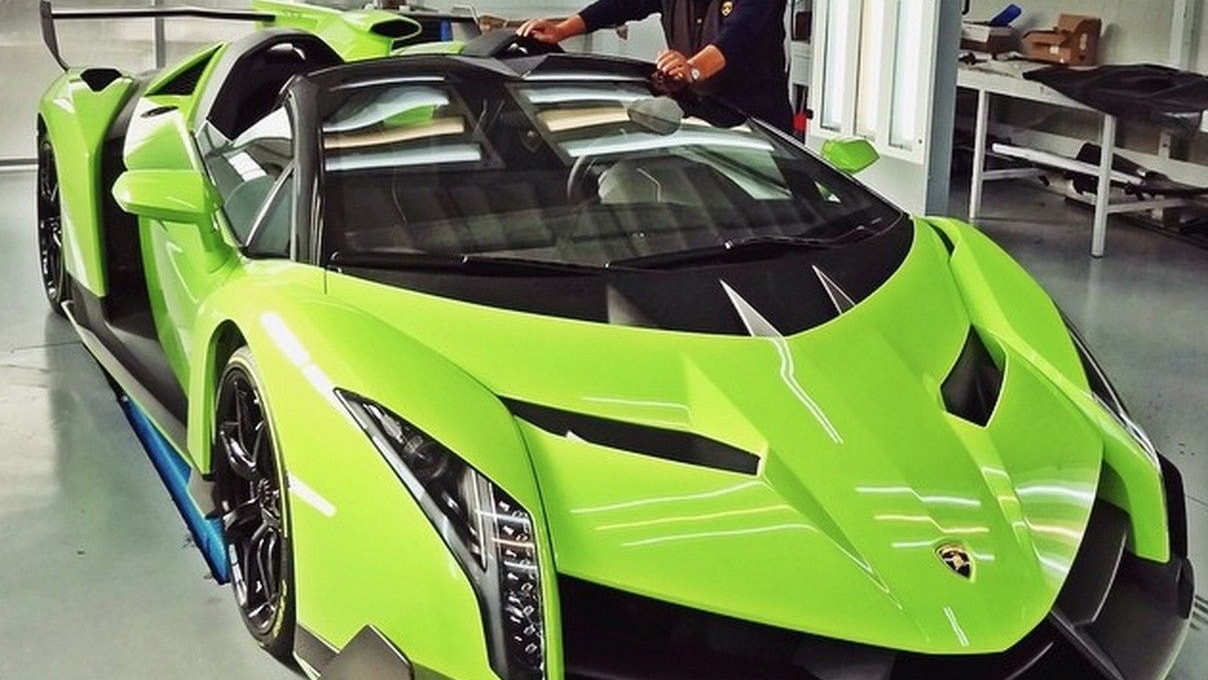 Valentino Balboni poses beside a Lamborghini Veneno Roadster painted in Verde Singh
