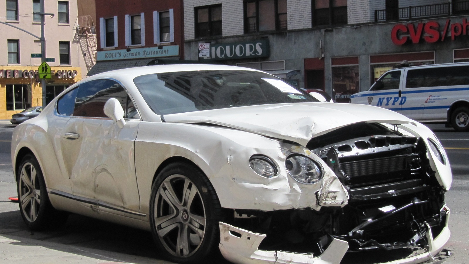 Wrecked 2013 Bentley Continental GT at the curb on a street in Manhattan