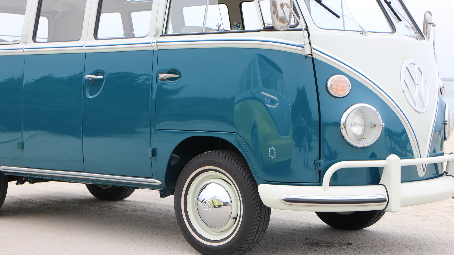 Volkswagen ID Buzz electric bus concept reflected in door of 1964 VW Microbus