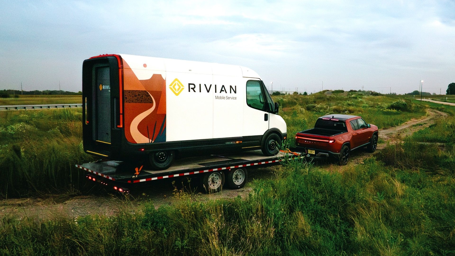 Rivian R1T towing Rivian service van