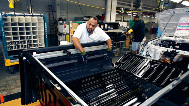 A UAW worker assembling a Hummer H3T